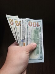 American hundred dollars lying in the hand