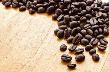 Roasted coffee beans on wooden background