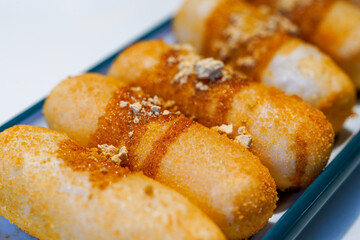 A plate of traditional Sichuan snacks, cakes with sugar and oil