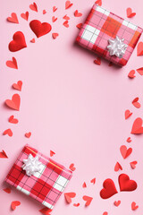 Gift boxes with hearts on a pink pastel background. Valentines mother's day christmas. Frame top view copy space flat lay