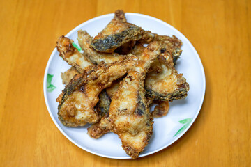 A plate of delicious fried grass carp belly closeup