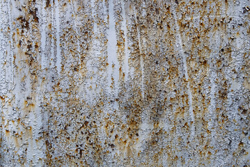white painted metal plate with cracks and rust