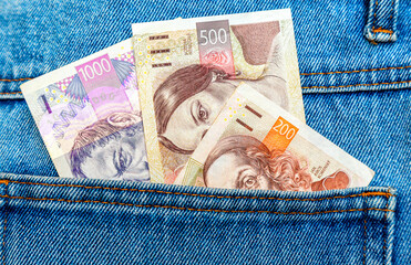 Czech koruna banknotes sticking out of the jeans pocket