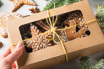 Christmas homemade gingerbread cookies in a gift box on a grey table