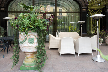 Empty chairs in outdoor cafe or restaurant. Tables and chairs at sidewalk cafe