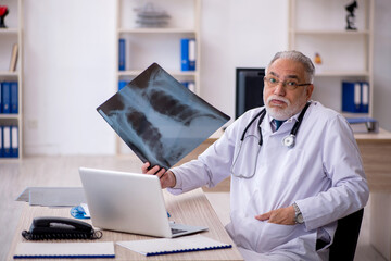 Fototapeta na wymiar Old male doctor radiologist working in the clinic