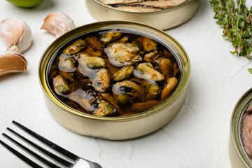 Mussels canned food, on white stone table background