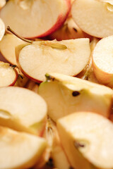 Sliced apples fruit. Vertical macro view of many slices of cut apples