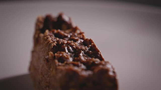 Close-up View, Spinning Plate With Chocolate Oat Cake, Yummy Piece of Cake - Steady Shot