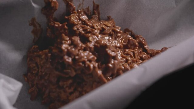 Putting chocolate batter into cake pan, baking a chocolate oat cake - Steady Shot