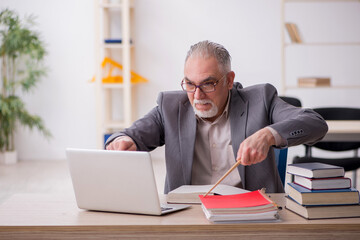 Aged male teacher in the classroom