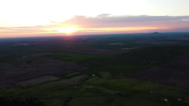 aerial drone of the sunset from the horizon over palouse, washington.  Steptoe butte.