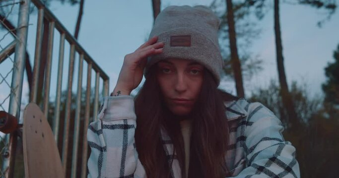 Skater girl looking at the camera in a skating park, urban and street lifestyle