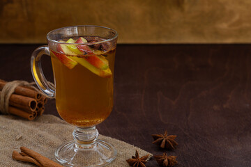 homemade apple cider with fresh apples, honey, spices: cinnamon, cardamon, anise, clove. hot fruit tea on the wooden table. mulled wine. traditional hot autumn drink. christmas drinks with cope space
