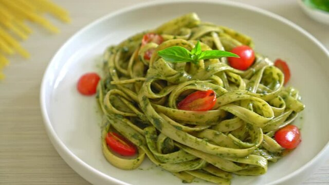 fettuccine spaghetti pasta with pesto sauce and tomatoes - vegan and vegetarian food style