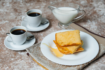 Two espresso cups on the table. Morning coffee. Breakfast with coffee. Beautiful table . Breakfast with cupcake and maple syrup.
