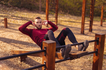 Man doing crunches while working out outdoors