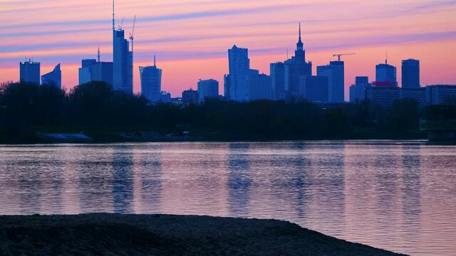 City of Warsaw in Poland at dusk, capital city downtown skyline, river view.