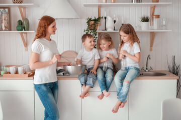 .Happy mother and children cooking in the kitchen