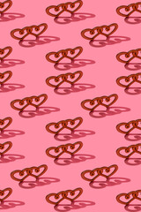 Wooden heart with hard shadow on a pink background. Trendy background for valentine's day. Vertical format, pattern