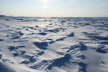 Winter landscape - frozen sea surface with snow.