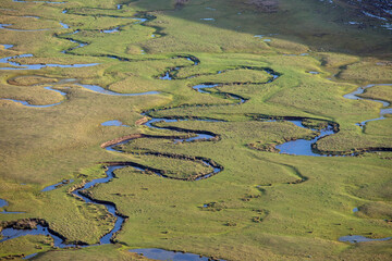 Meandering stream with mountains and clouds at The Persembe Plateau at Ordu, Turkey