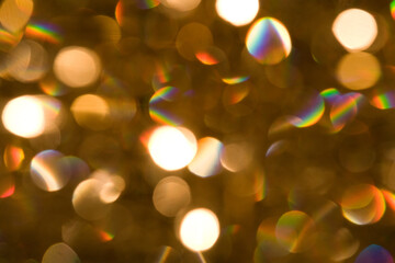 abstract, defocused, gold, white and rainbow sequin and spotlight bokeh background texture