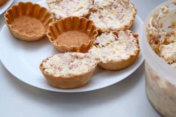 On the plates are ready-made baskets with pate.