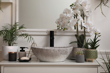 Obraz na płótnie Canvas Stylish sink and beautiful houseplants in bathroom. Interior design