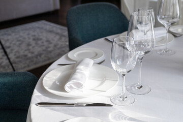 table serving with tablewear glasses and plates in restaurant. selected focus