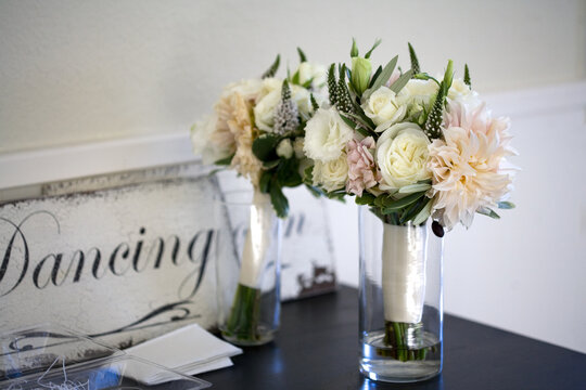 bride and bridesmaid's wedding bouquets with dancing sign