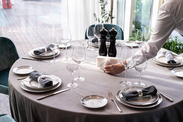 table serving with tablewear glasses and plates in restaurant. selected focus