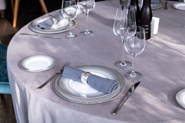 table serving with tablewear glasses and plates in restaurant. selected focus