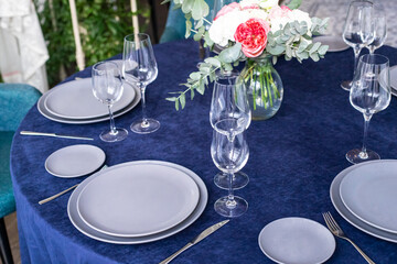 table serving with tablewear glasses and plates in restaurant. selected focus