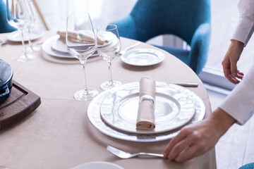 table serving with tablewear glasses and plates in restaurant. selected focus