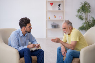 Old man visiting young male psychotherapist