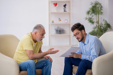 Old man visiting young male psychotherapist