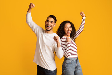 Big Luck. Overjoyed Arab Couple Raising Fists And Exclaiming With Excitement