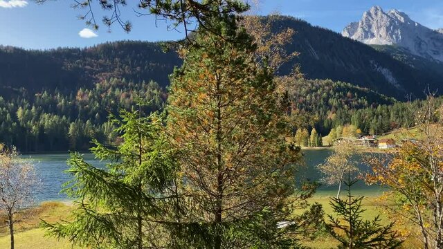 Panning shot of Lauter Lake with peaks of the Karwendel mountains in the background, very close to the bavarian town of Mittenwald in Germany