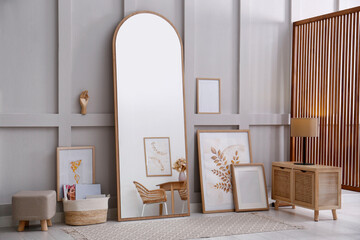 Light room interior with large mirror near wall