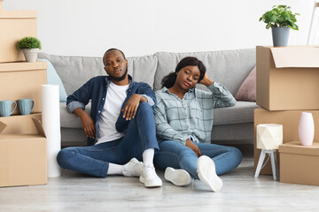 Sad Black Spouses Sitting On Floor Tired After Moving To New Home