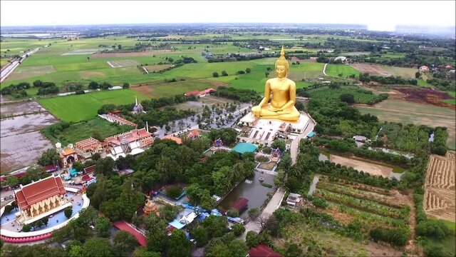 Footage of Amazing Aerial View of Large Golden Seated Buddha Image at Wat Muang Temple in Ang Thong Province, Thailand