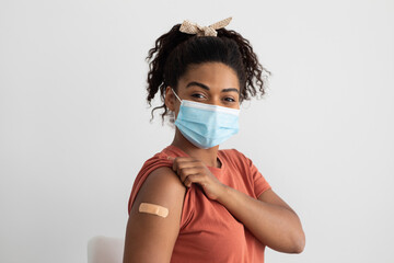 African american woman with face mask after immunization, closeup