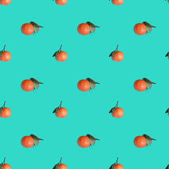 Seamless pattern with ripe orange tangerines on turquoise background