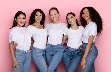 Group Of Five Happy Multiracial Ladies Hugging Over Pink Background