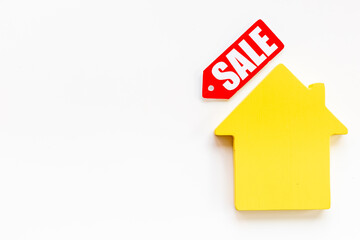 House for sale - sale tag with wooden house figure