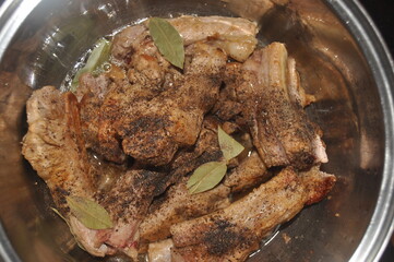Fried pork ribs stewed in gravy with onion and spices. Delicious meat lunch dish.