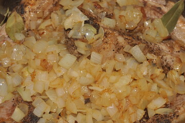 Fried pork ribs stewed in gravy with onion and spices. Delicious meat lunch dish.