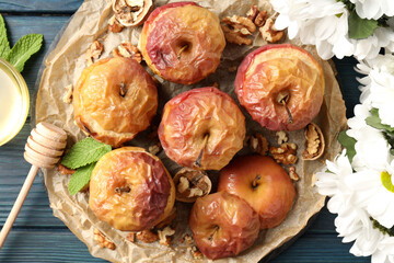 Concept of tasty food with baked apples on wooden table