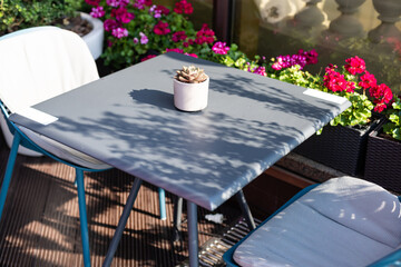 Street view of a Cafe terrace with empty tables and chairs